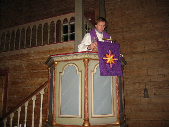 vicar fastening the hanging for the pulpit
